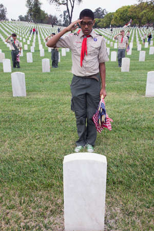 Boyscout saluting for one of 85, 000 US Flags at 2014 Memorial Day Event, Los Angeles National Cemetery, California, USAのeditorial素材