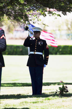 Marine playing taps at Memorial Service for fallen US Soldierのeditorial素材