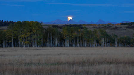 Lunar Eclipse moon over San Juan Mountains, Hastings Mesa with old western fence in foreground, San Miguel County, Coloradoのeditorial素材