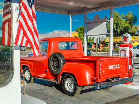 July 22, 2016 - Red Dodge Pickup truck parked in front of vintage gas station in Santa Paula, Californiaのeditorial素材