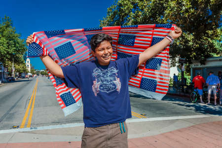 JULY 4, 2016 - Citizens of Ojai California celebrate Independence Day - hispanic man holds American flagsのeditorial素材