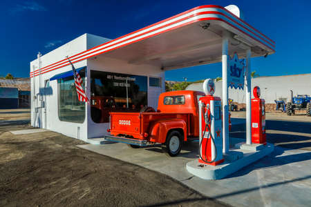 July 22, 2016 - Red Dodge Pickup truck parked in front of vintage gas station in Santa Paula, Californiaのeditorial素材