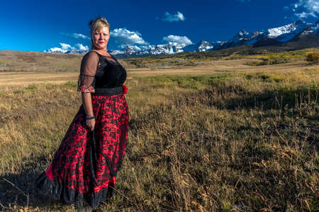 OCTOBER 2017, Ridgway, Colorado: Amanda wears Red Saloon Girl Western Costume on historic Last Dollar Ranch, Hastings Mesaのeditorial素材