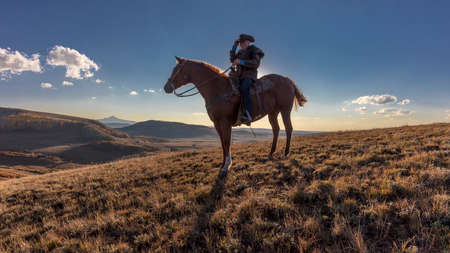 OCT 4, 2017, RIDGWAY COLORADO - Older Cowboy, Howard Linscott looks out over historic Last Dollar Ranch on Hastings Mesa, SW Colorado, San Juan Mountainsのeditorial素材