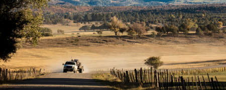 September 28,, 2018, USA - Pickup truck drives County Road 24 near Ridgway Colorado looking towards San Juan Mountainsのeditorial素材