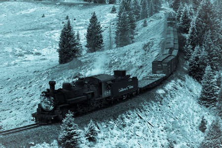 OCTOBER 9, 2018 - New Mexico, USA - Cumbres & Toltec Scenic Steam Train, from Chama, New Mexico to Antonito, Colorado over Cumbress Pass 10,015 Elevation - in Autumn and fresh snow - along Highway 17のeditorial素材