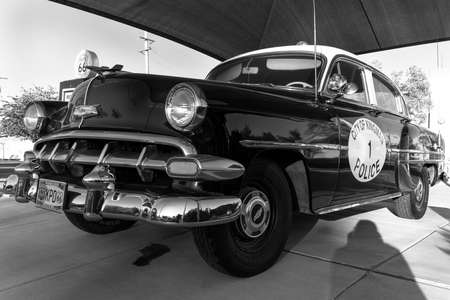 Kingman, Arizona, USA, July 2, 2018 - old Route 66, shows vintage Police Car and Gas Pump in black and whiteのeditorial素材