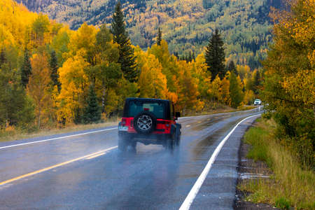 SEPTEMBER, 2018 - OURAY, SILVERTON COLORADO - red jeep drives Wet autumn road goes from Ouray to Silverton Colorado, the "Million Dollar Highway" with color, Route 550のeditorial素材