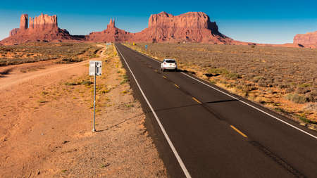 SEPT 14, 2018 - Monument Valley, Utah, USA - SUV drives toward Monument Valley on Utah/Arizona border, American southwestのeditorial素材