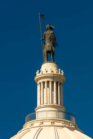 OCTOBER 11, 2018 Oklahoma City USA - A statue created by Enoch Kelly Haney sits atop the Oklahoma State Capitol, Oklahoma City OKのeditorial素材
