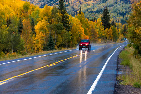 SEPTEMBER, 2018 - OURAY, SILVERTON COLORADO - red jeep drives Wet autumn road goes from Ouray to Silverton Colorado, the "Million Dollar Highway" with color, Route 550のeditorial素材