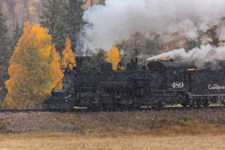 OCTOBER 9, 2018 - New Mexico, USA - Cumbres & Toltec Scenic Steam Train, from Chama, New Mexico to Antonito, Colorado over Cumbress Pass 10,015 Elevation - in Autumn and fresh snow - along Highway 17のeditorial素材