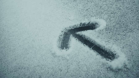 Arrow sign carved into snowの写真素材