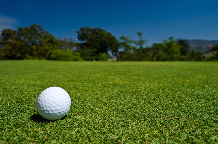 a glof ball on green fieldの写真素材