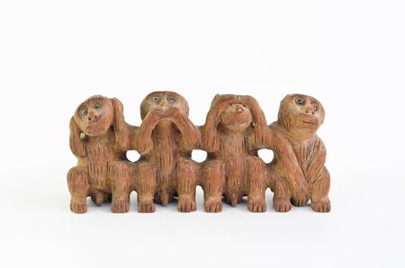 three monkeys and a special one isolated on white backgroundの写真素材