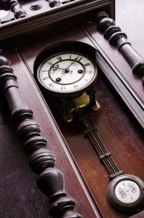 closeup of antique beautiful wooden pendulum clockの写真素材