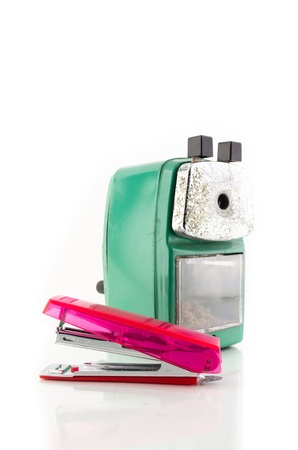 old green sharpener and pink stapleer on white backgroundの写真素材