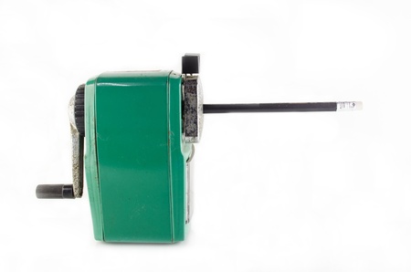old green stapler in side view with pencil on white backgroundの写真素材