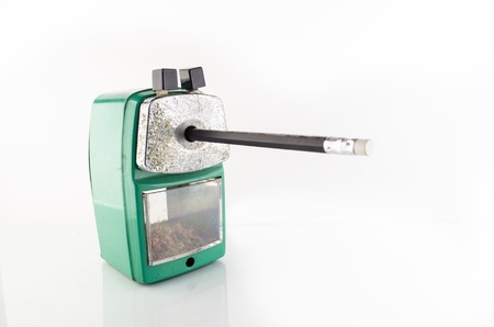 old green stapler in side view with pencil on white backgroundの写真素材