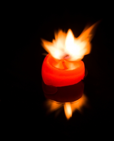 heart candle on fire in dark backgroundの写真素材