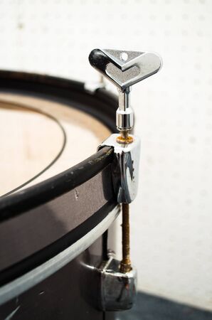 close up of drum tuning key on drum edgeの写真素材