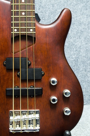close up of a wooden bass with four volume controller