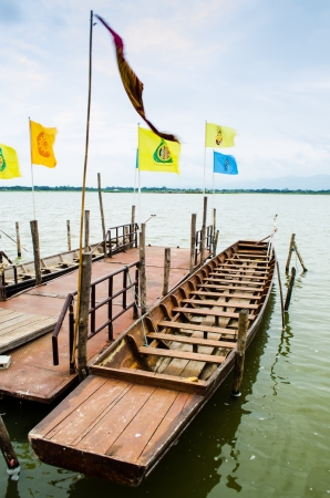 wooden rowboat at dock in the lake of thailandのeditorial素材