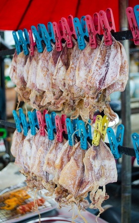dry squid is famous seafood snack in thailand that you can find it at street shopの写真素材
