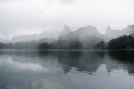 view of foggy mountain in ratchaprapa dam in thailandの写真素材