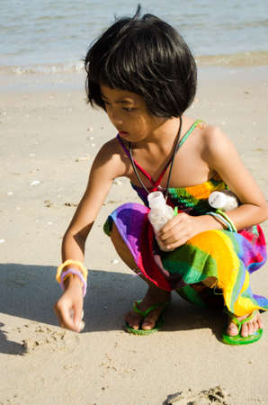Chonburi THAILAND, January, a happy girl in rainbow suit playing on th beach on 9 january 2013 at Cha-Am beachの写真素材