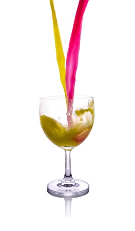 colored water splash in high glass isolated on white backgroundの写真素材