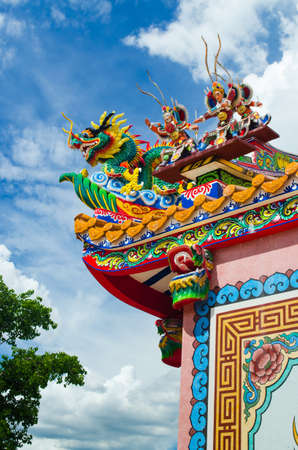 chinese style roof with dragon against blue skyの写真素材