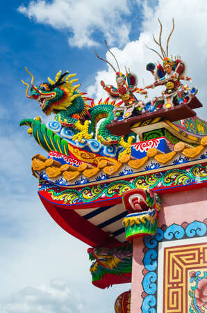 chinese style roof with dragon against blue skyの写真素材