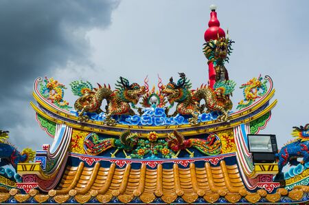 chinese style roof with dragon against blue skyの写真素材