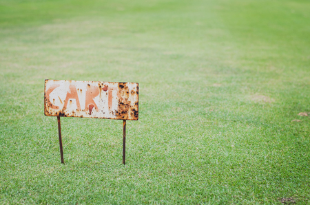 rusty cart sign in golf courseの写真素材