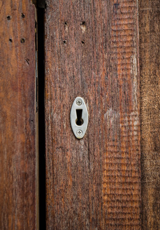 close up of keyhole on wooden wallの写真素材