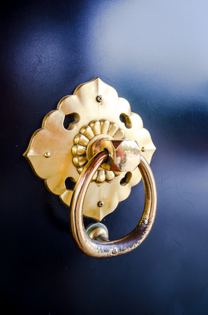 old golden holder on black doorの写真素材