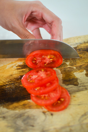 sliced tomato on wood tableの写真素材