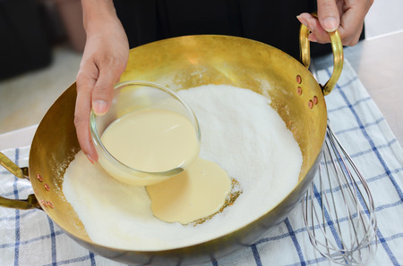 bun ingredient, sugar flour and putting melt butter into the panの写真素材