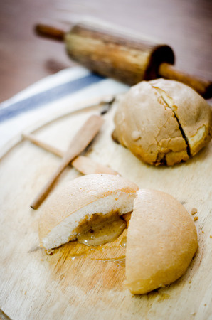 close up of coffee bun on wooden plate