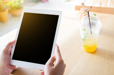 woman using tablet in coffee shop in the moringの写真素材