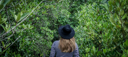 happy thai girl with green forest in backgroundの写真素材