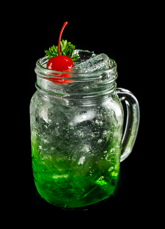 green sparkling soda on dark black groundの写真素材