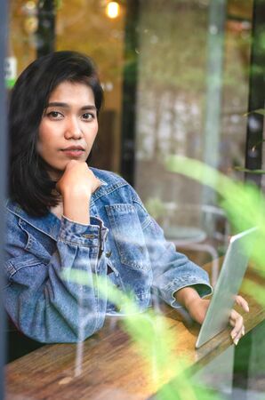 happy asian woman using tablet in cafeの写真素材