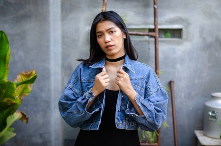 thai lady in black dress with jean jacketの写真素材