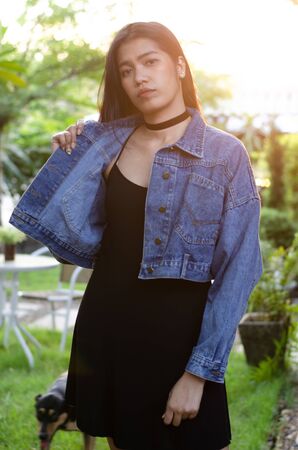 thai lady in black dress with jean jacketの写真素材