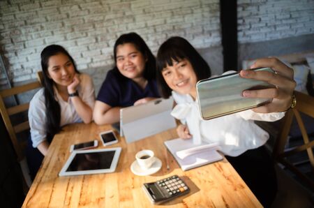 group of business woman taking selfie in cafeの写真素材