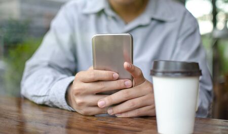man using smart phone in cafeの写真素材