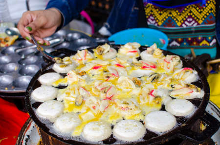kanom krok seafood is thai fusion food, it is cake with seafood toppingの写真素材