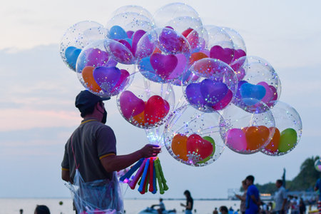 CHONBURI/  THAILAND : October 19, 2022 : photo of a mercant selling fantasy balloon in the evening at Bang Saen Beach/ Thailandのeditorial素材